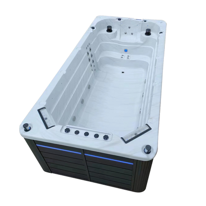 Side view of single temperature swimspa with two waterfall features, pop up speakers and LED cabinet lighting 