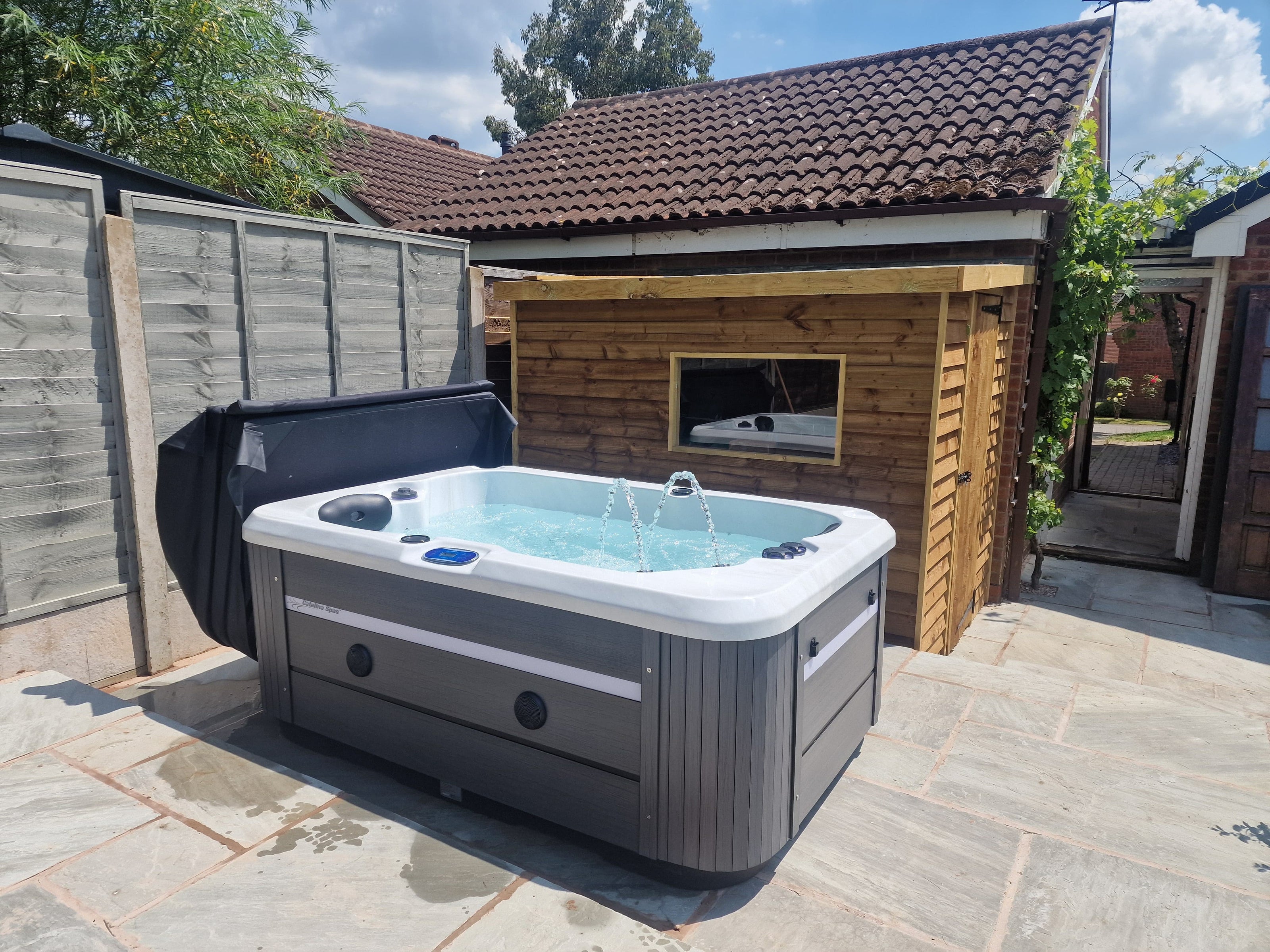CX-2 Hot tub installed in a garden next to a shed