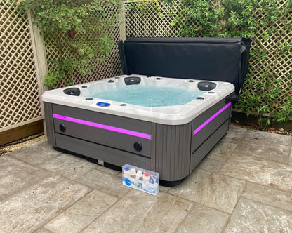 Hot Tub in garden with pink lights on