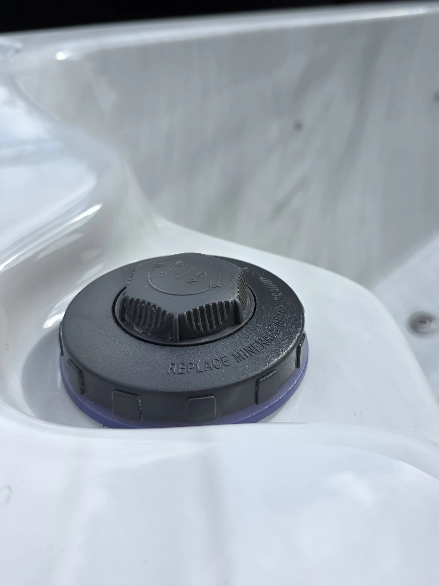 Close up of the chemical feeder on a hot tub