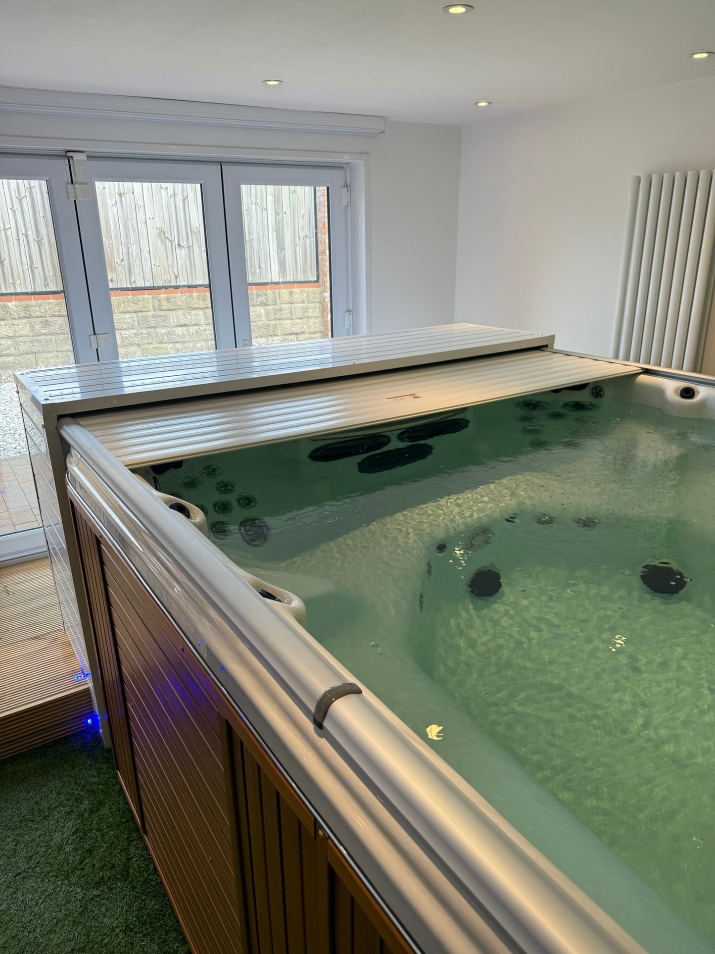 Swim spa installed inside with EZ Glide automated cover fitted.