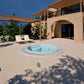 circular round white hot tub sunk in ground patio with pergola 