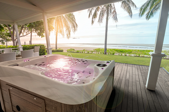 Coast Spas hot tub featuring an infinity edge overlooking the beach