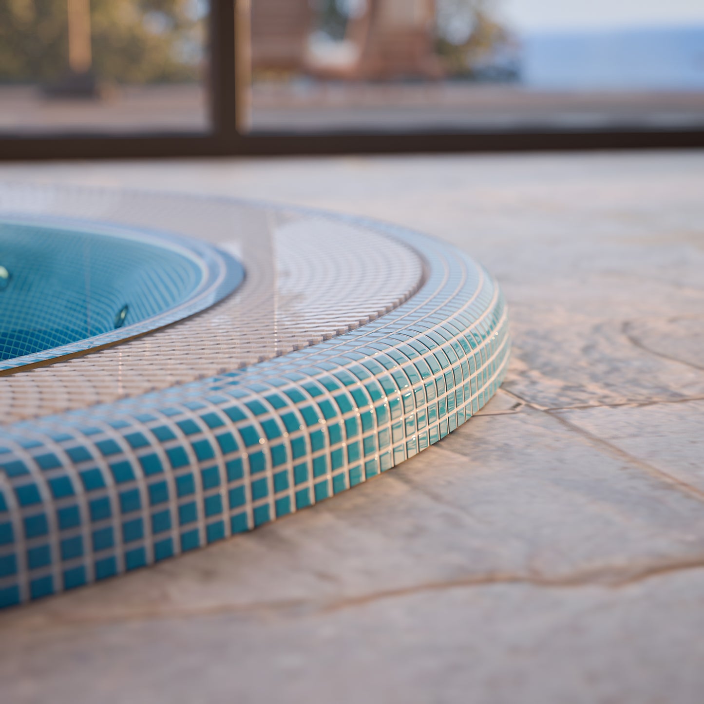 edge of a mosaic hot tub installed inground 