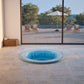 inground mosaic hot tub with a view out to a swimming pool