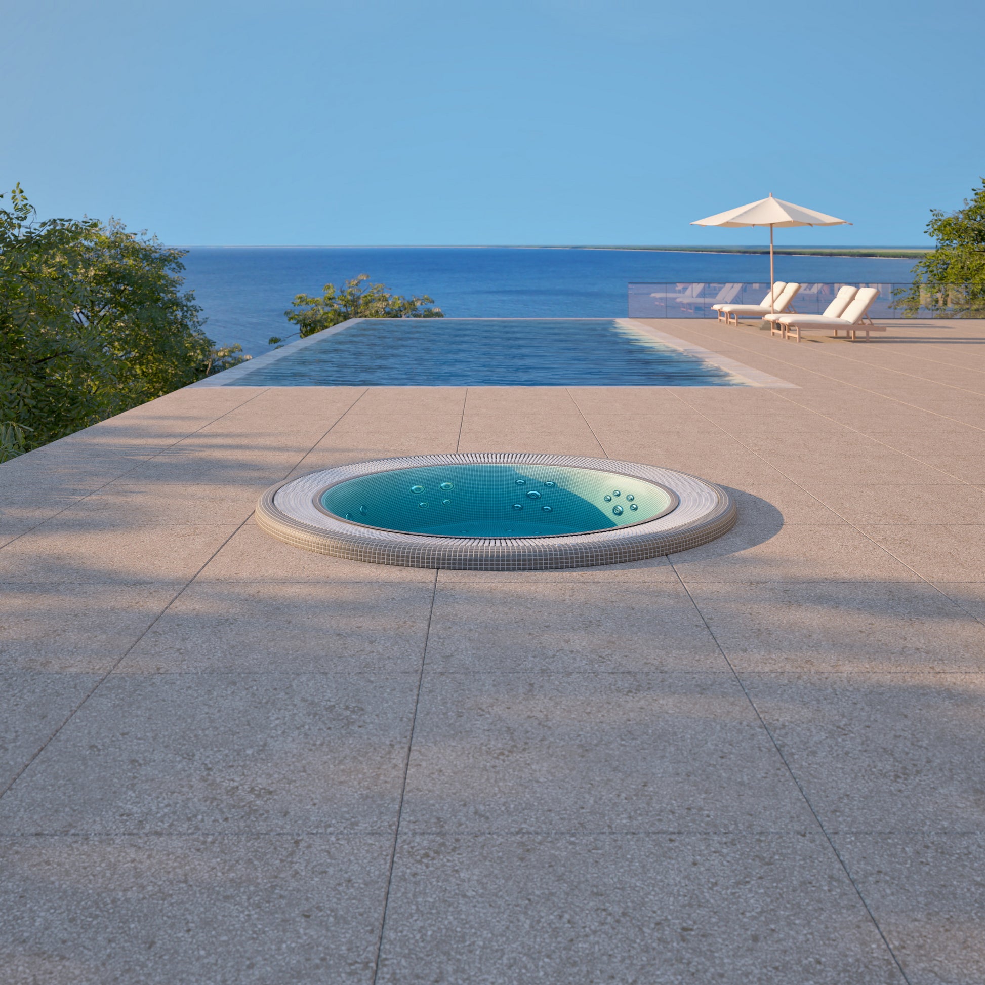 mosaic hot tub installed inground in a patio with a view of the ocean and clear blue sky.